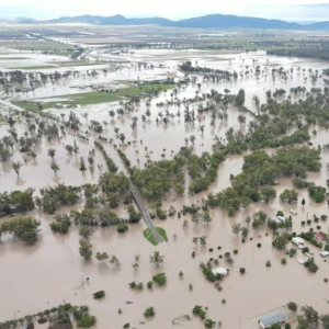 Aerial view of flooded landscape with submerged trees and terrain, illustrating flood extent for geospatial analysis